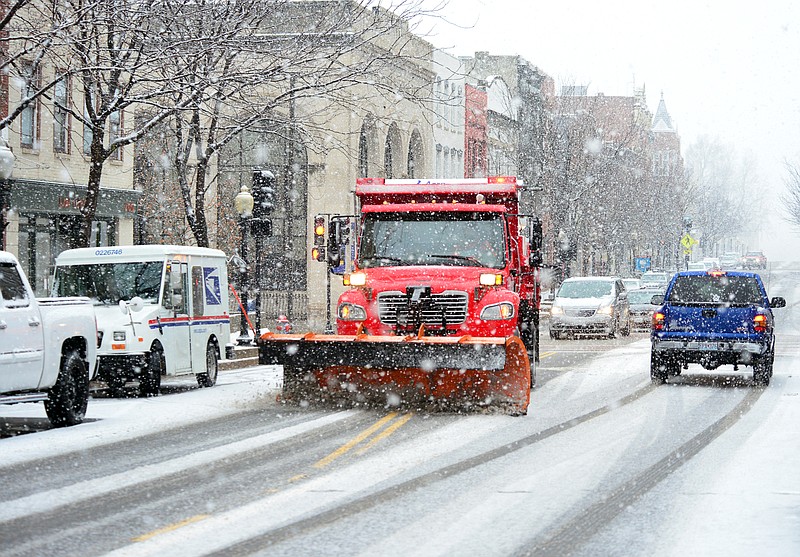 
A snow plow clears downtown areas of Jefferson City as heavy snow falls Friday, Jan. 11, 2019.