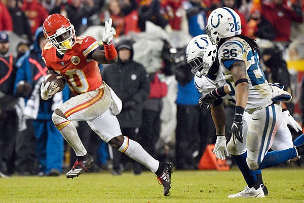 Chiefs wide receiver Tyreek Hill gestures as he runs past Colts safety Clayton Geathers (26) and linebacker Anthony Walker during the second half of Saturday's playoff game at Arrowhead Stadium.