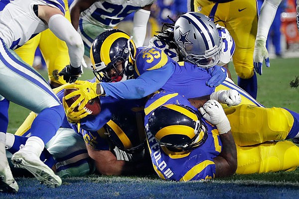 Rams running back C.J. Anderson scores a touchdown during Saturday night's playoff game against the Cowboys in Los Angeles.