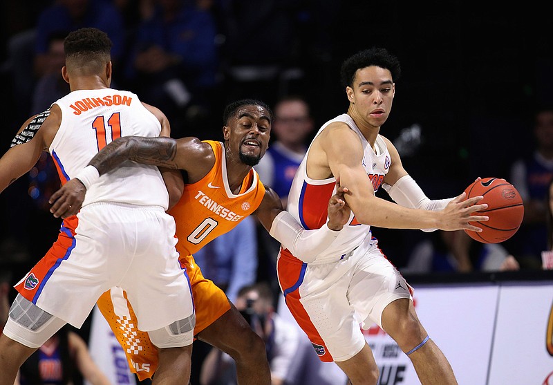 Tennessee guard Jordan Bone (0) is fouled by Florida forward Keyontae Johnson (11) while guarding Florida guard Andrew Nembhard (2) during the first half of an NCAA college basketball game Saturday, Jan. 12, 2019, in Gainesville, Fla. (AP Photo/Matt Stamey)