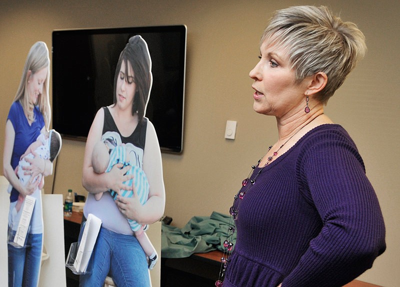 In this Nov. 12, 2014 file photo, Melinda Ridenhour, director of nutrition services for the Cole County Health Department, unveiled life-sized photographs of mothers breastfeeding their baby during a press conference in Jefferson City.