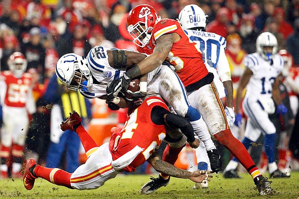 Chiefs linebacker Anthony Hitchens (top) and safety Jordan Lucas (bottom) tackle Colts running back Marlon Mack during the second half of Saturday's AFC divisional playoff game at Arrowhead Stadium.