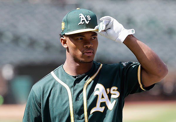 In this June 15, 2018, file photo, Athletics draft pick Kyler Murray looks on before a game between the Athletics and the Angels in Oakland, Calif. Representatives of the Athletics and Major League Baseball met Sunday with Murray a day before the Oklahoma quarterback's deadline to enter the NFL draft, a person with direct knowledge of the session said.