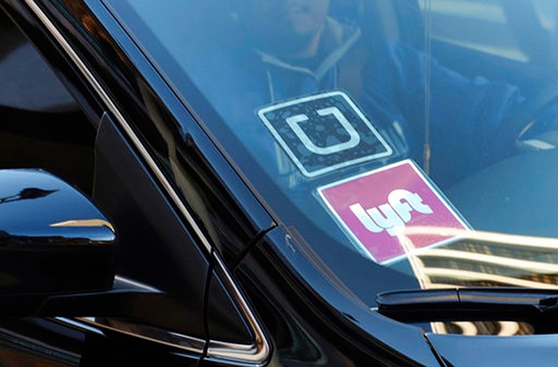 A ride-share car displays Lyft and Uber stickers on its front windshield on Jan. 12, 2016, in downtown Los Angeles, Calif.  Ride-hailing giants Uber and Lyft have launched subscription plans promising savings for trips to the gym, to work or around town. The ride-hailing companies stand to gain by increasing customer loyalty in a competitive market and securing more predictable revenue at a time when both companies are heading to an initial public offering.      

