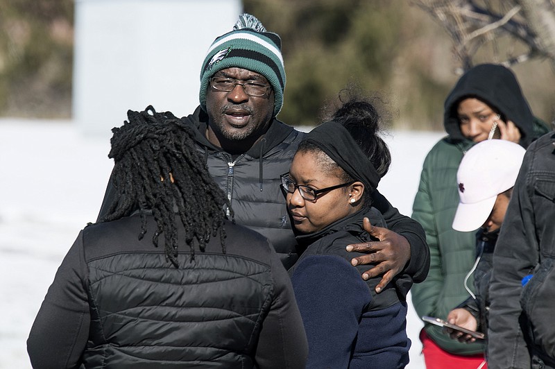 People watch as officials respond to reports of an active shooter at a UPS facility Monday, Jan. 14, 2019 in Logan Township, N.J. (Joe Lamberti/Camden Courier-Post via AP)