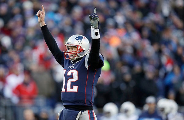 Patriots quarterback Tom Brady celebrates a touchdown run by Sony Michel during the first half of Sunday's playoff game against the Chargers in Foxborough, Mass.