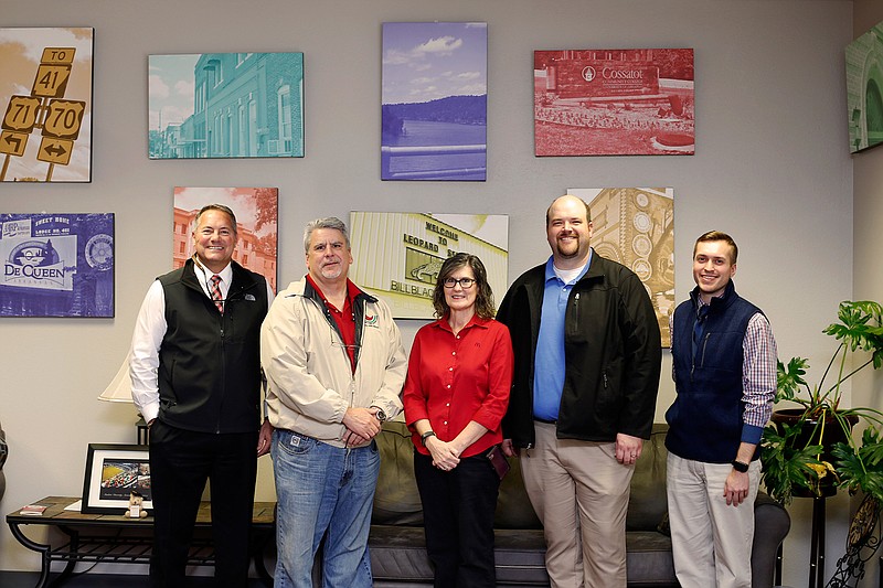 McDonald's in De Queen, Ark., recently donated artwork depicting various Sevier County landmarks to the University of Arkansas Cossatot Foundation. Shown are, left to right, Dr. Steve Cole, UA Cossatot chancellor, Steve and Celia Montgomery, McDonald's  owners, Johnathan Bauer, McDonald's supervisor and Dustin Roberts, UA Cossatot coordinator of development.