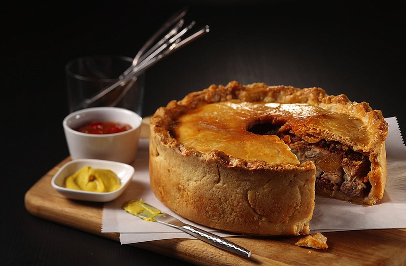 Pork goes into the crust (in the form of lard) and into the filling (with two kinds of sausage) in this meat pie. (Abel Uribe/Chicago Tribune/TNS) 