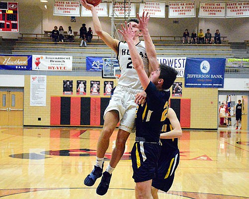 Ben Cooper (left) and the Helias Crusaders will host the Jefferson City Jays tonight at Rackers Fieldhouse.