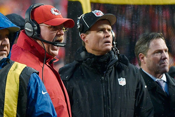 Chiefs coach Andy Reid yells to fans in the stands to stop throwing snowballs onto the field, during the first half of Saturday's playoff game against the Colts at Arrowhead Stadium.