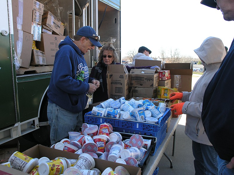 Carol Loesch and J.C. Howard unpack the mobile food items onto a serving table in Russellville.