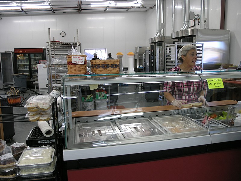 Deloris Shirk serves a customer at the new deli inside Shirk's Country Market at Centertown.