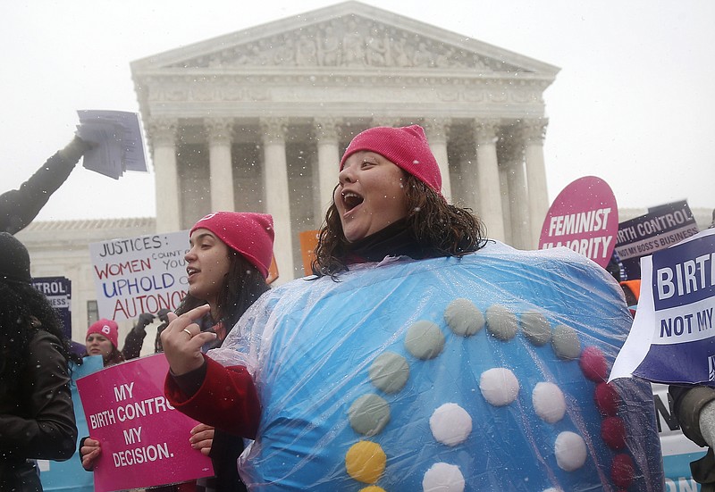 FILE - In this March 25, 2014, file photo, Margot Riphagen of New Orleans, wears a birth control pill costume as she protests in front of the Supreme Court in Washington. Millions of American women are receiving birth control at no cost to them through workplace health plans, the result of the Obama-era Affordable Care Act, which expanded access to contraception. The Trump administration sought to allow more employers to opt out because of religious or moral objections. But its plans were put on hold by two federal judges, one in Pennsylvania and the other in California, in cases that could eventually reach the Supreme Court. (AP Photo/Charles Dharapak, File)