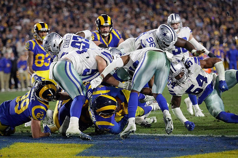 Los Angeles Rams running back C.J. Anderson scores against the Dallas Cowboys during the second half in an NFL divisional football playoff game Saturday, Jan. 12, 2019, in Los Angeles. (AP Photo/Marcio Jose Sanchez)