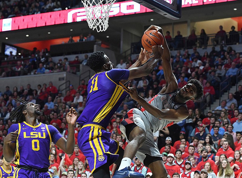 LSU forward Kavell Bigby-Williams (11) blocks a shot by Mississippi guard Blake Hinson, right, during the first half of an NCAA college basketball game in Oxford, Miss., Tuesday, Jan. 15, 2019. (AP Photo/Thomas Graning)