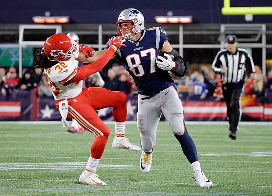 In this Oct. 14, 2018, file photo, Patriots tight end Rob Gronkowski gives a stiff arm to Chiefs free safety Ron Parker after catching a pass during the second half of a game in Foxborough, Mass. Parker was released Tuesday by the Chiefs.