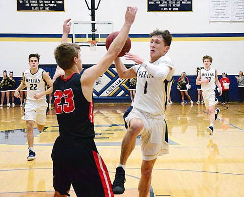 Nick Brandt of Helias drives to the basket against the defense of Ben Folz of the Jays during Tuesday night's game at Rackers Fieldhouse.