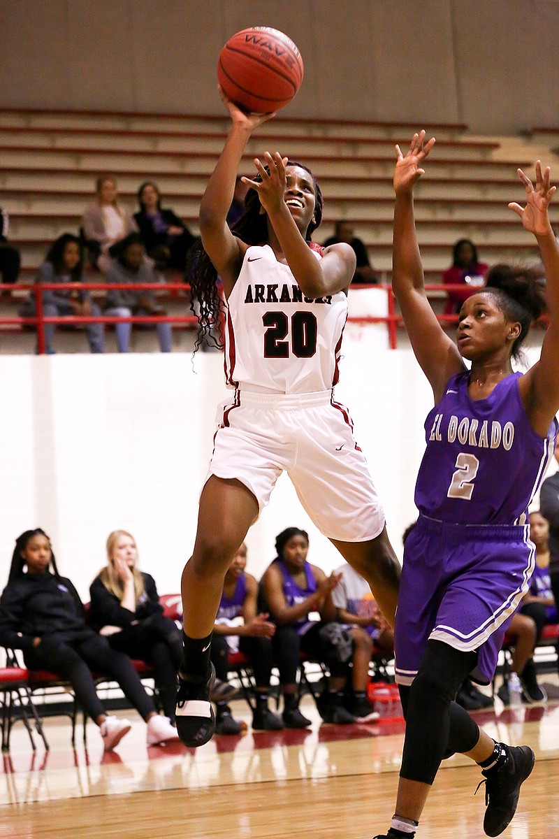 Lady Backs' Jayla Easter shoots the ball while being guarded by a Lady Wildcats on Tuesday at Arkansas High School.