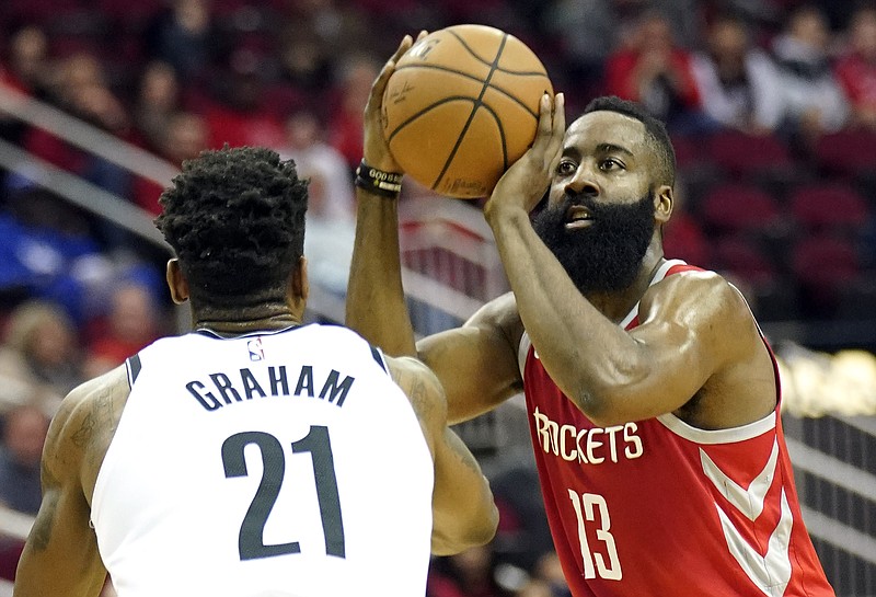 Houston Rockets' James Harden (13) shoots as Brooklyn Nets' Treveon Graham (21) defends during the first half of an NBA basketball game Wednesday, Jan. 16, 2019, in Houston. (AP Photo/David J. Phillip)