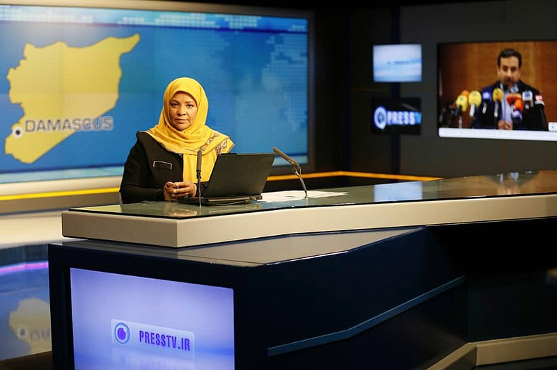 This undated photo provided by Iranian state television's English-language service, Press TV, shows American-born news anchor Marzieh Hashemi at studio in Tehran, Iran.  The elder son of Hashemi says his mother is being held in the United States, but has not been charged with anything.  Hussein Hashemi says she was detained Sunday,  Jan. 13, 2019, as she was leaving St. Louis for Denver. He says she had filmed a Black Lives Matter documentary in St. Louis after visiting family in New Orleans.  (Press TV via AP)