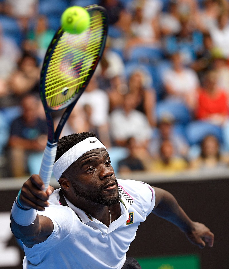 United States' Frances Tiafoe reaches for a forehand return to South Africa's Kevin Anderson during their second round match at the Australian Open tennis championships in Melbourne, Australia, Wednesday, Jan. 16, 2019. (AP Photo/Andy Brownbill)