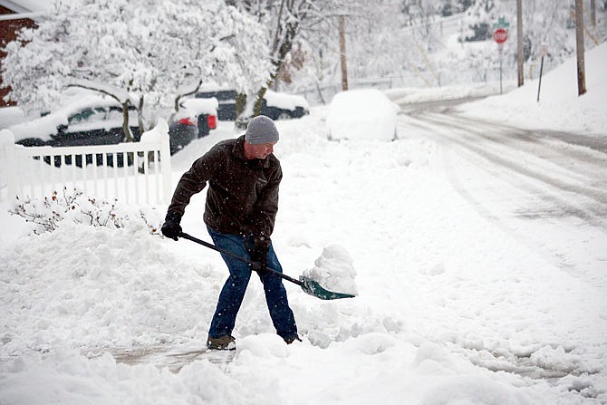 Don Johnston shovels snow from his driveway Saturday along Swifts Highway. Another significant snow storm is in the forecast for this weekend. City officials remind residents to remove snow from sidewalks adjacent to their properties to help pedestrians. 