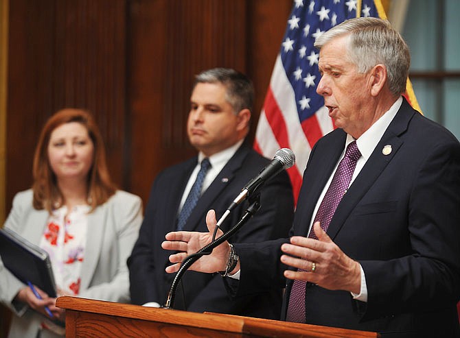 With Zora Mulligan and Rob Dixon to his right, Gov. Mike Parson held a press conference Thursday in his Capitol office to announce the details of three executive orders signed earlier in the day.