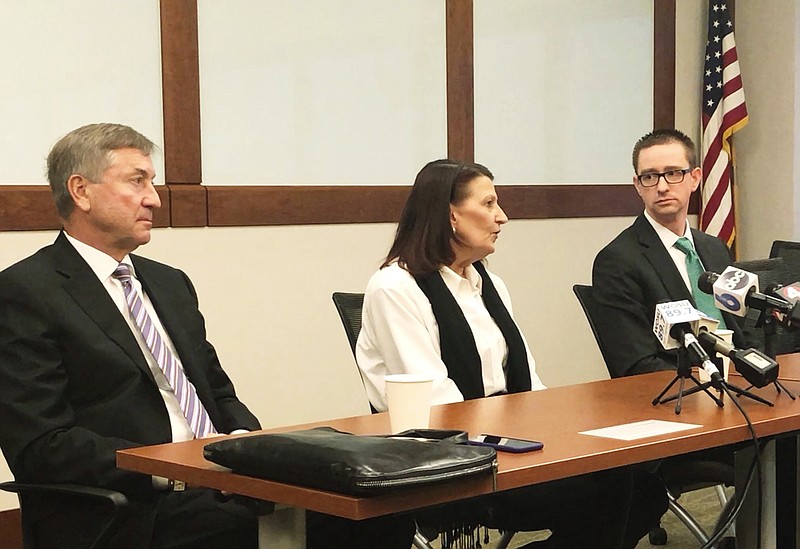Attorneys Gerry Leeseberg, left, and Craig Tuttle, right, listen to Christine Allison, of Columbus, discuss the death of her 44-year-old husband, Troy, and her resulting wrongful death lawsuit against Mount Carmel Health System at an office in Columbus, Ohio, Thursday, Jan. 17, 2019. It's one of several lawsuits filed after Mount Carmel announced that a doctor ordered pain medicine for at least 27 near-death patients in dosages significantly bigger than necessary to provide comfort. (AP Photo/Kantele Franko)