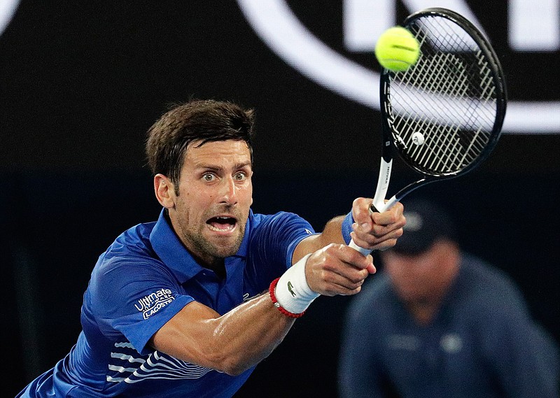 Serbia's Novak Djokovic makes a backhand return to France's Jo-Wilfried Tsonga during their second round match at the Australian Open tennis championships in Melbourne, Australia, Thursday, Jan. 17, 2019. (AP Photo/Aaron Favila)