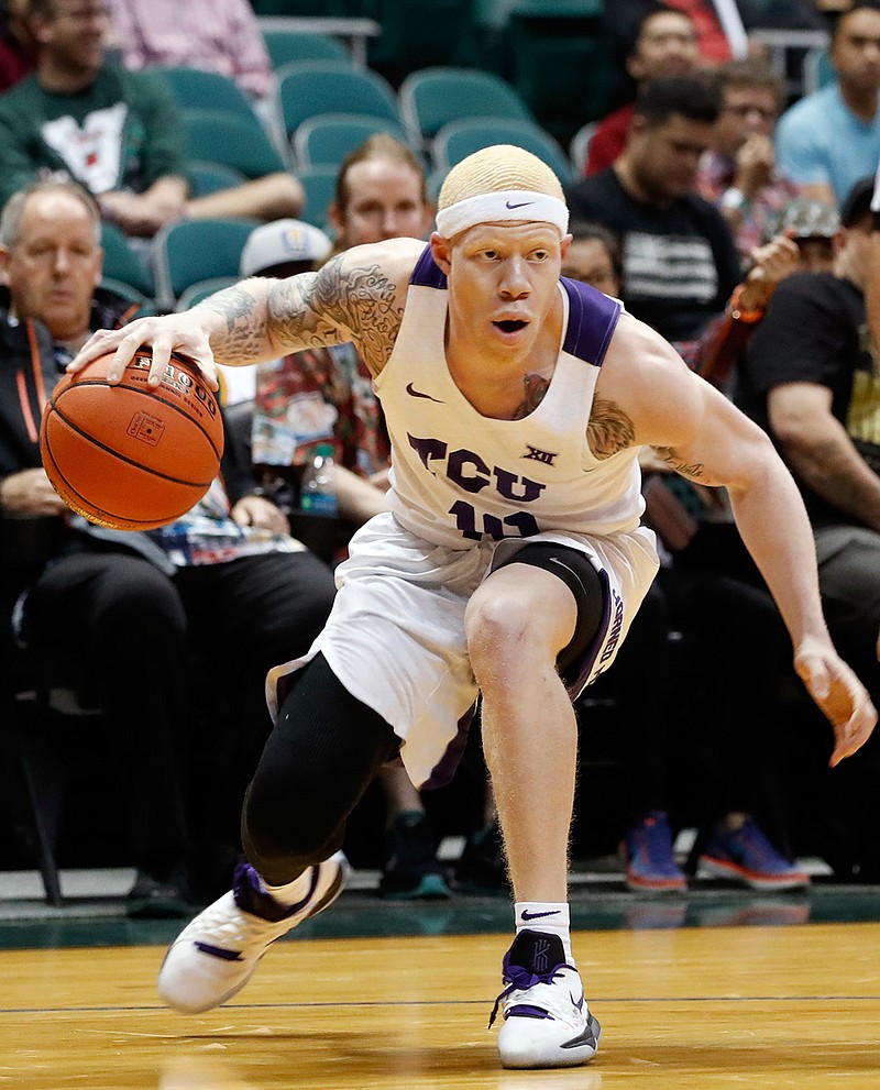 In this Dec. 25, 2018, file photo, TCU guard Jaylen Fisher tries to get past an Indiana State defender during the first half of an NCAA college basketball game at the Diamond Head Classic in Honolulu. Fisher will miss the rest of this season because of ongoing issues with his surgically repaired right knee, and won't return to the program next season. Coach Jamie Dixon made the announcement about Fisher's future on Thursday, Jan. 17, 2019. (AP Photo/Marco Garcia, File)