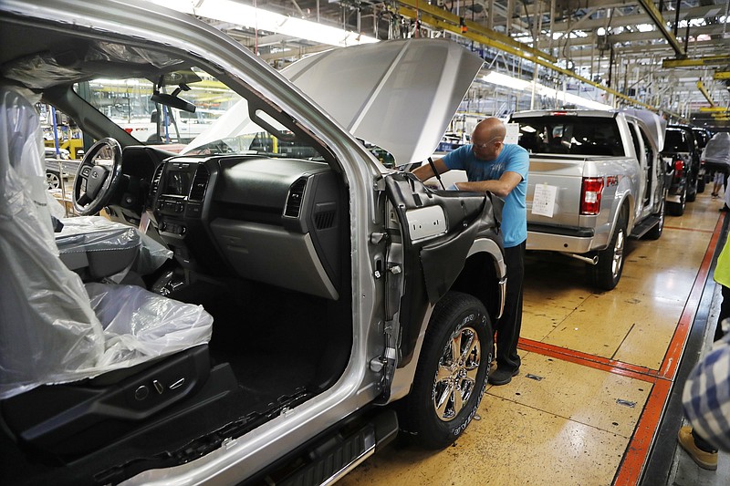 FILE- In this Sept. 27, 2018, file photo a United Auto Workers assemblyman works on a 2018 Ford F-150 truck being assembled at the Ford Rouge assembly plant in Dearborn, Mich. On Friday, Jan. 18, 2019, the Federal Reserve reports on U.S. industrial production for December. (AP Photo/Carlos Osorio, File)