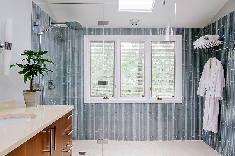 This photo shows a Bethesda, M.D., master bathroom. Interior designer Nadia Subaran says homeowners increasingly want glass-enclosed showers that they can walk directly into without any step or door, as seen in this design by Aidan Design. (Robert Radifera/Aidan Design via AP)