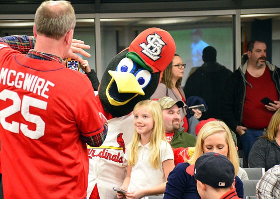 Fredbird poses for a photo with a young fan during Friday night's annual visit of the Cardinal Caravan at the Missouri Farm Bureau.
