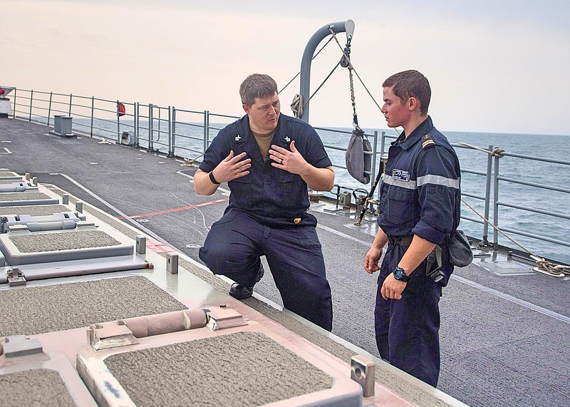 U.S. Navy Gunner's Mate 1st Class Dustin Smillie, from Prescott, Ark., left, explains the functions of a vertical launch system to French Marine Nationale Second-matre Martin during exercise Intrepid Sentinel on Tuesday aboard the guided-missile cruiser USS Mobile Bay (CG 53) in the Arabian Gulf. Intrepid Sentinel brings together the John C. Stennis Strike Group, France's Marine Nationale, United Kingdom's Royal Navy and the Royal Australian Navy for a multinational exercise designed to enhance war-fighting readiness and interoperability between allies and partners. The John C. Stennis Strike Group is deployed to the U.S. 5th Fleet area of operations in support of naval operations to ensure maritime stability and security in the Central Region, connecting the Mediterranean and the Pacific through the western Indian Ocean and three strategic choke points. (U.S. Navy photo by Mass Communication Specialist 3rd Class Nick Bauer)
