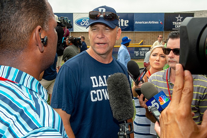 In this July 28, 2018, file photo, Dallas Cowboys offensive coordinator Scott Linehan talks with the media after morning practice at NFL football training camp, in Oxnard, Calif. Scott Linehan is out as offensive coordinator of the Dallas Cowboys only days after coach Jason Garrett sent mixed messages about the oft-criticized assistant's future. Garrett said in a statement released by the team Friday, Jan. 18, 2019, that he and Linehan had some open discussions this week and mutually agreed that a change was needed after five seasons. (AP Photo/Gus Ruelas, File)