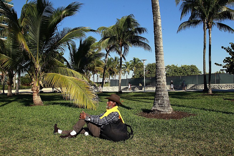 Jose Montesino takes in the sunshine in Lummus Park on South Beach on Jan. 10, 2019, where a new municipal prosecutor program has targeted the homeless for low-level offenses. (Carl Juste/Miami Herald/TNS) 