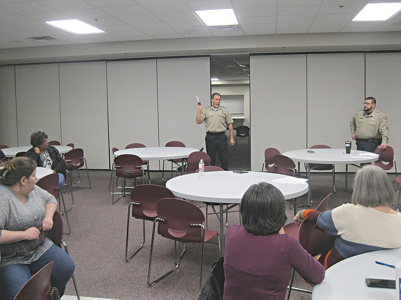 University of Arkansas security officer Monte Stringfellow holds a pistol as he speaks to students and faculty attending an active-shooter response class at University of Arkansas-Cossatot in Ashdown.
