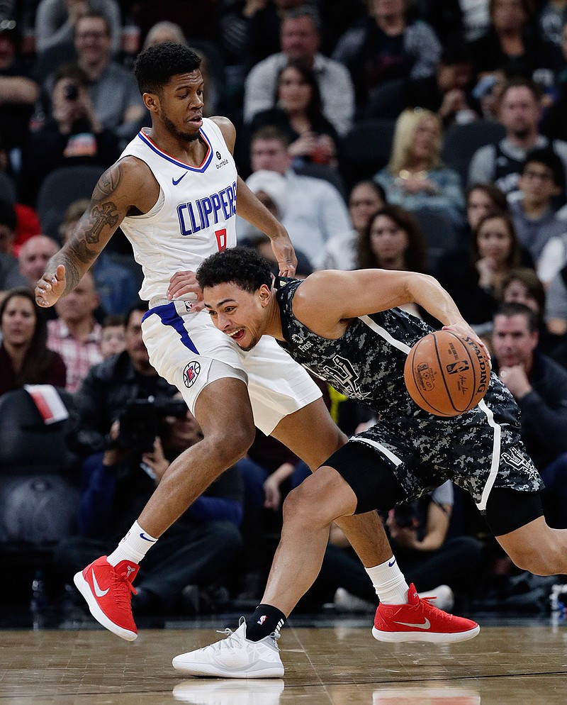 San Antonio Spurs guard Bryn Forbes (11) drives around Los Angeles Clippers guard Tyrone Wallace (9) during the first half of an NBA game, Sunday, Jan. 20, 2019, in San Antonio.