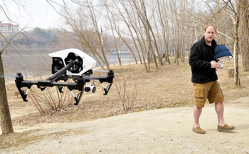 
In this March 12, 2015 file photo, James O'Guinn observes the screen and the equipment as he flies a DJI Inspire drone over the Missouri River at the Noren Access in north Jefferson City.