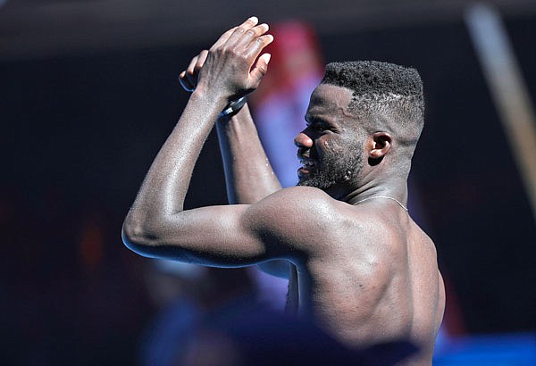 Frances Tiafoe celebrates after defeating Grigor Dimitrov in Sunday's fourth-round match at the Australian Open in Melbourne, Australia.