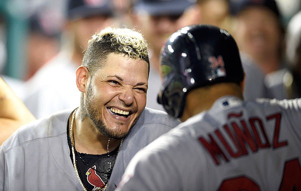 In this Sept. 4, 2018, file photo, Yadier Molina celebrates his grand slam with Cardinals teammate Yairo Munoz in the dugout during the ninth inning of a game against the Nationals in Washington.