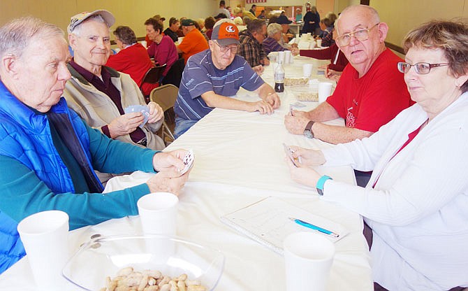 Chuck and Betty Ball (far left and far right) face off over cards while (left to right) Bob Schuck, Earl Ingram and Walter William look on during the 2017 Loafer's Week. The Mexico card-playing group comes down to Loafer's Week every year.