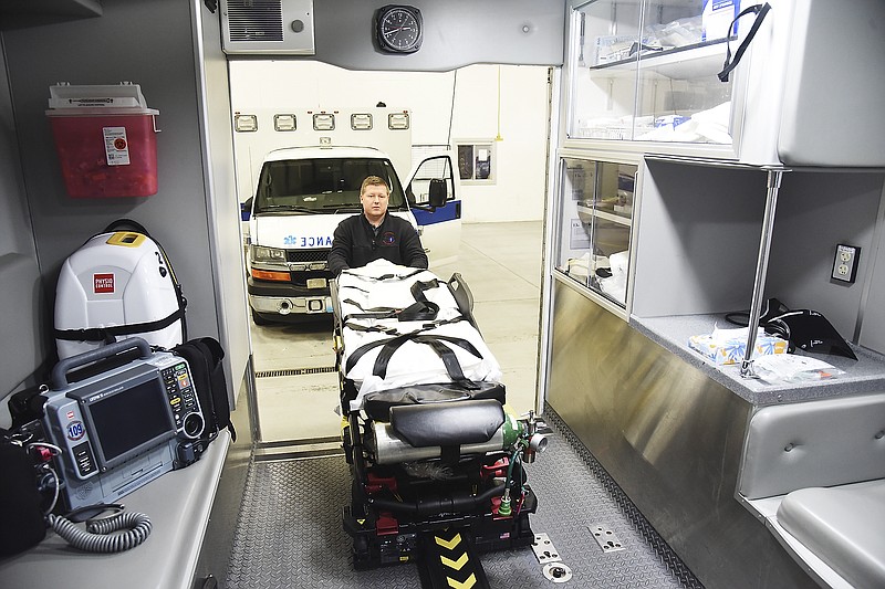 Brandon Ruediger, an EMT for Cole County Emergency Medical Services, places a gurney back into an ambulance Thursday, Jan. 24, 2019.