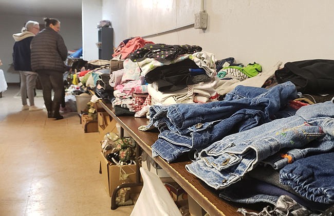 People look at clothes in Harvest Time Ministries, one of the organizations in Holts Summit that has been accepting donations of clothes and toiletries for victims of Monday's apartment fire.