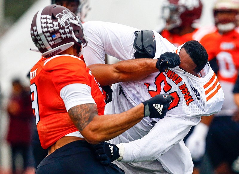 South offensive tackle Tytus Howard of Alabama State (58) loses his helmet in a drill with South defensive end Montez Sweat of Mississippi State (9) during practice for the Senior Bowl on Tuesday in Mobile, Ala.