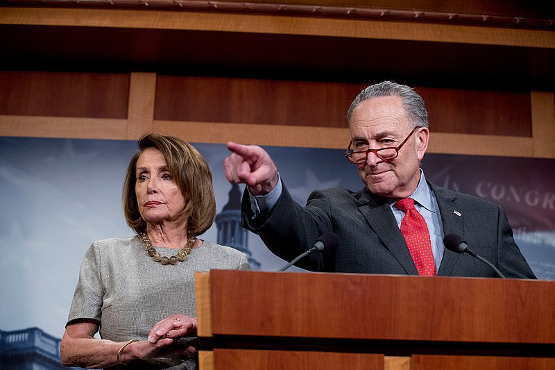 Senate Minority Leader Sen. Chuck Schumer of N.Y., accompanied by Speaker Nancy Pelosi of Calif., left, calls on a reporter during a news conference on Capitol Hill in Washington, Friday, Jan. 25, 2019, after President Donald Trump announces a deal to reopen the government for three weeks. (AP Photo/Andrew Harnik)