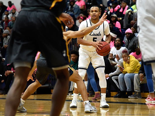 John Burton of Lincoln looks for a teammate to pass the ball to during Saturday afternoon's 78-65 win against Central Oklahoma at Jason Gym.