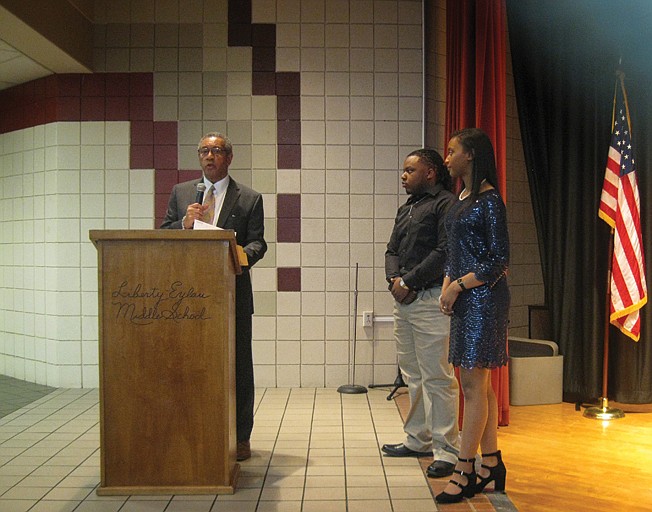 Michael Bursey, president of the Macedonia High School Alumni Association, left, pays tribute to Texas High School students Madison Brown, right, and Marquez Roach for their speech and musical talent presentations Saturday during the 19th annual Tri-School Alumni Association Unity Banquet at Liberty-Eylau Middle School.