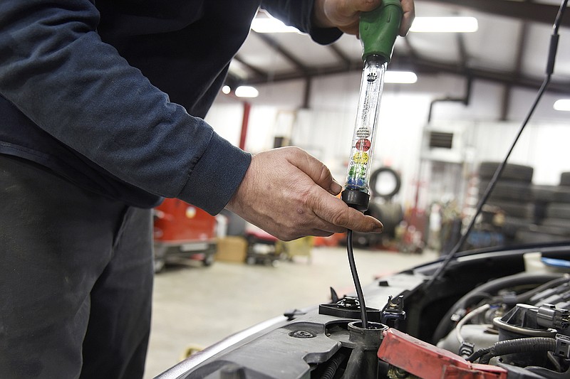 Car mechanic Roy Wright tests antifreeze on cars ahead of cold weather Monday at Jim Lewis Tire Pros. With winter storms on the way, Jefferson City is expected to have freezing temperatures as low as minus 3 degrees in the next couple days. Drivers are recommended to test their car batteries and make sure their cars are equipped with antifreeze so they don't stall due to cold weather.