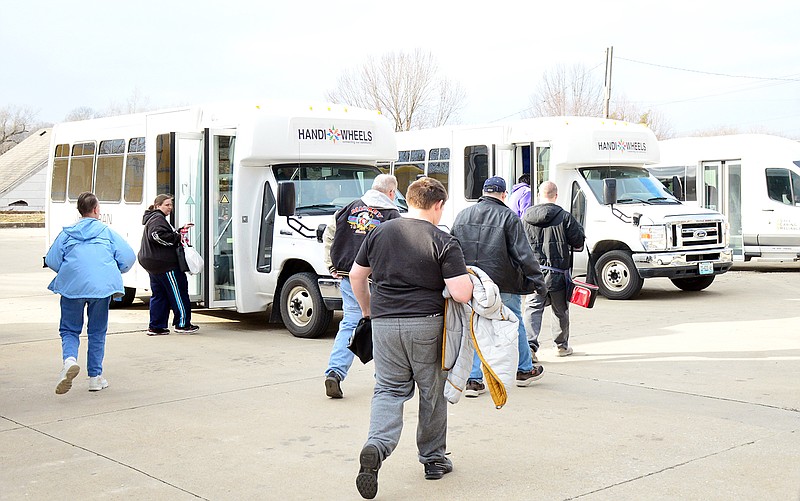 Dozens of Handi-Wheels clients board buses Monday outside of  Capitol Projects at 2001 E. McCarty Street. JeffTran is in the process of re-certifying Handi-Wheels clients. 